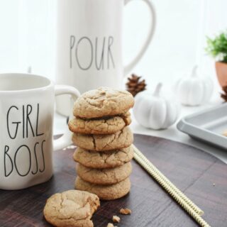 stack of spice cake mix cookies next to a glass mug and pitcher