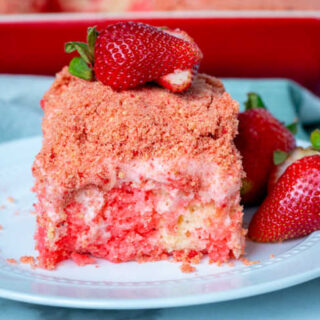 strawberry crunch poke cake with fresh strawberries