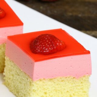 strawberry jello cake with strawberries on top