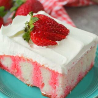strawberry jello poke cake with strawberries on top