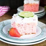 A strawberry margarita cake with a strawberry on the side.