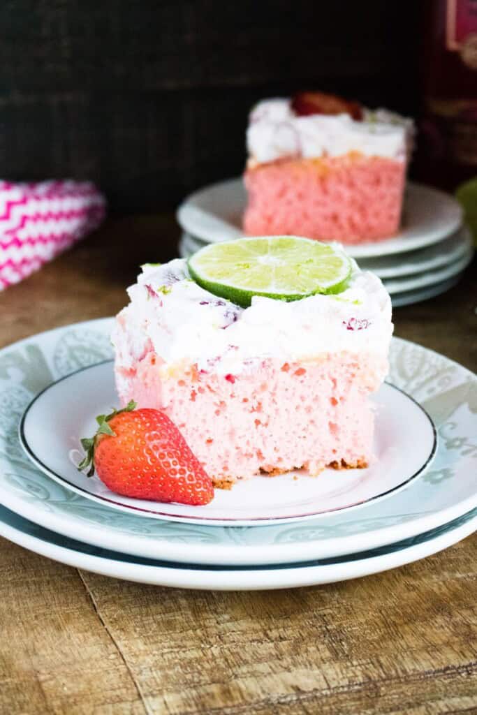 A strawberry margarita cake with a strawberry on the side.