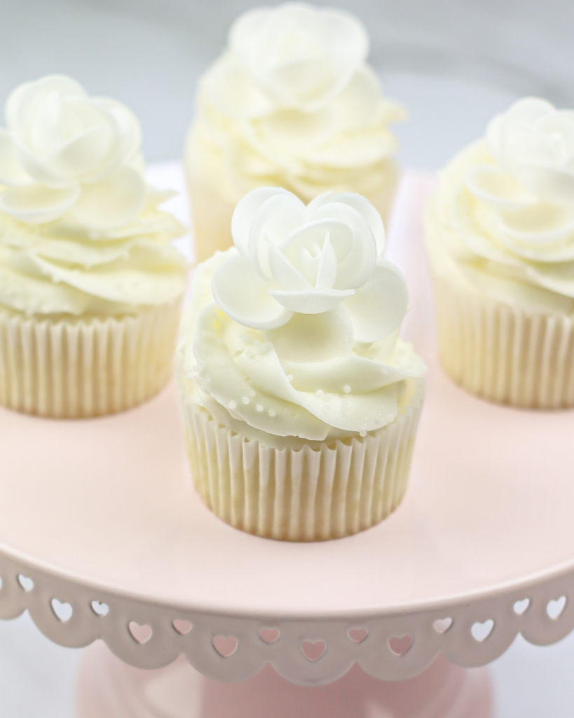White Wedding Cupcakes on a cake stand.