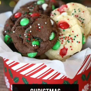 chocolate and vanilla christmas cake mix cookies with red and green m&ms and sprinkles, in a basket