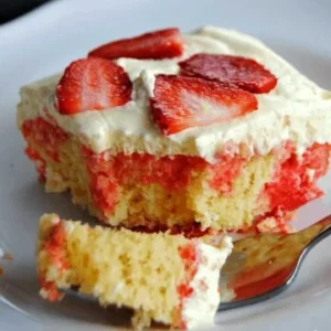 lemon strawberry poke cake with strawberry slices on top