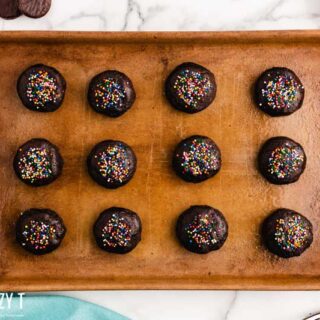 rows of chocolate peppermint patty cookies with rainbow sprinkles on top, on a tray