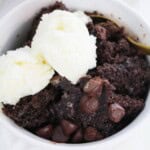 A serving of the chocolate lava cake with whipped cream on top.