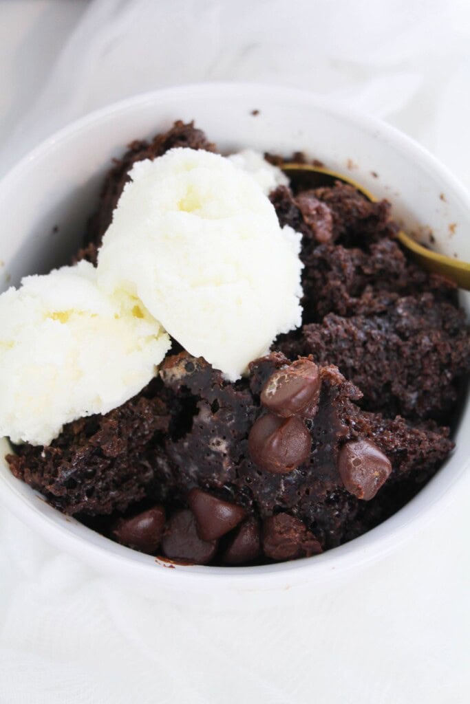 A serving of the chocolate lava cake with whipped cream on top.