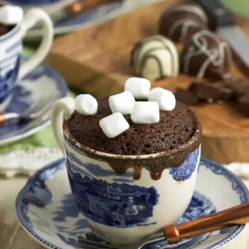 a mug of hot chocolate mug cake with mini marshmallows on top