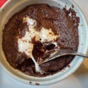 hot chocolate mug cake with melted marshmallow and chocolate in the center