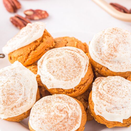 pumpkin cake mix cookies with white frosting on top
