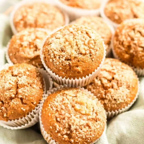 a bunch of golden brown, pumpkin muffins