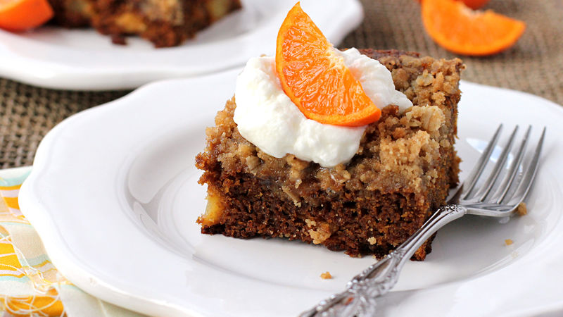 Gingerbread and apple coffee cake with whipped cream and orange