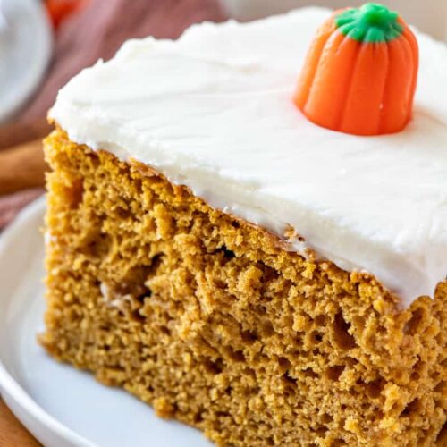 Pumpkin spice cake with frosting and pumpkin candy topping