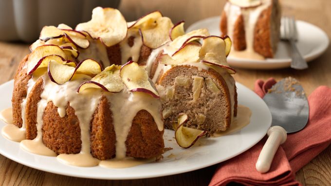 Golden bundt cake with glaze and apple slices on top
