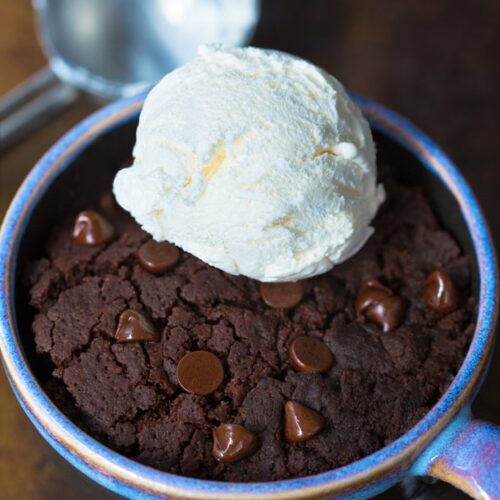 Gluten free brownie in a mug with chocolate chips and ice cream