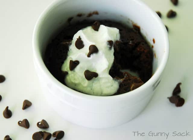 Brownie in a mug with chocolate chips and whipped cream