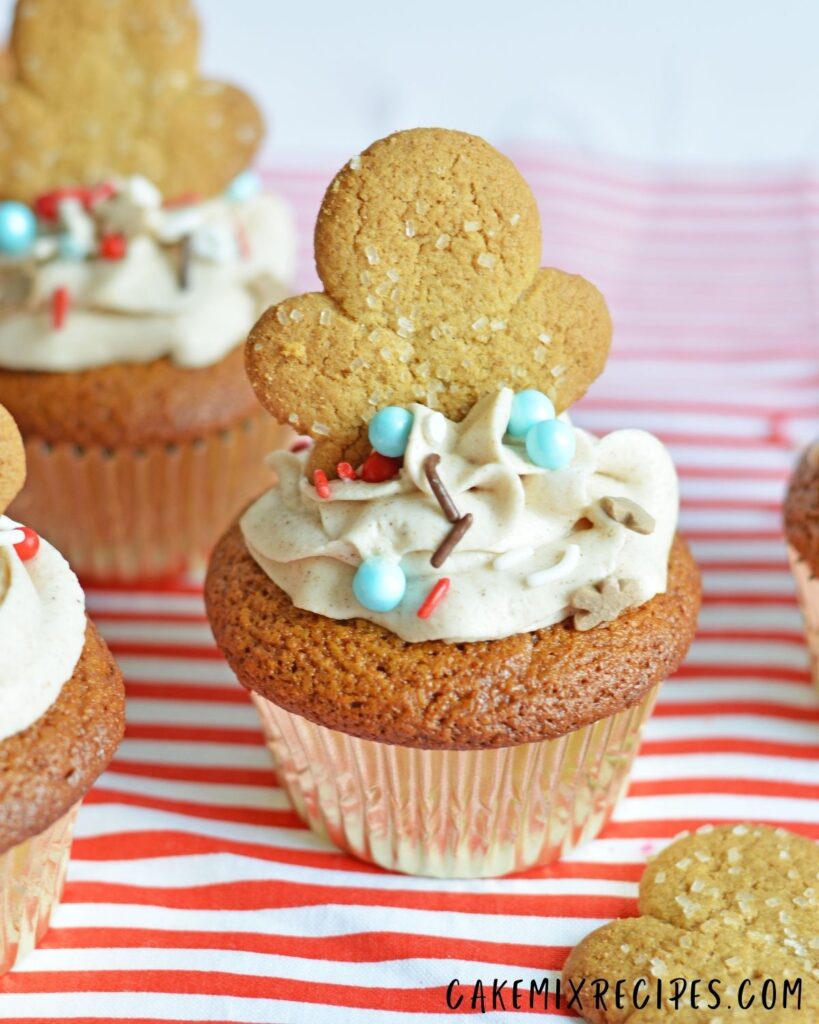 Gingerbread Men Cupcakes with sprinkles on the top of the frosting.