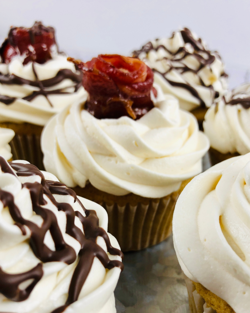 several cupcakes with bacon.