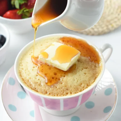 Pancake in a mug with syrup and butter