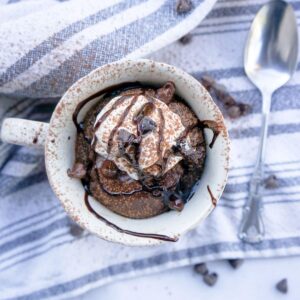 Chocolate protein brownie mug cake with chocolate drizzle