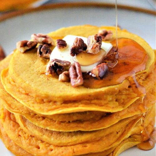 Pumpkin pancakes with butter, syrup, and walnuts