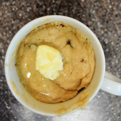 Pancake in a mug with butter and chocolate chips