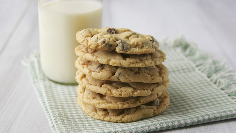 Stacked chocolate chip cookies with milk