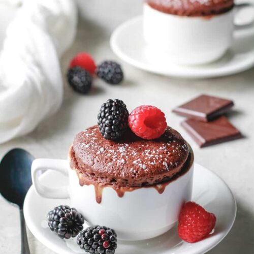 Fluffy chocolate mug cake with raspberries and blackberries