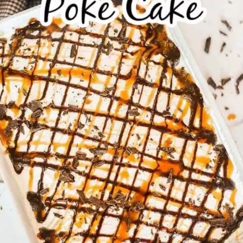 Image of poke cake topped with chocolate and caramel drizzle with chocolate pieces