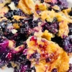 A close up on the fruity dessert with a crumbly topping.