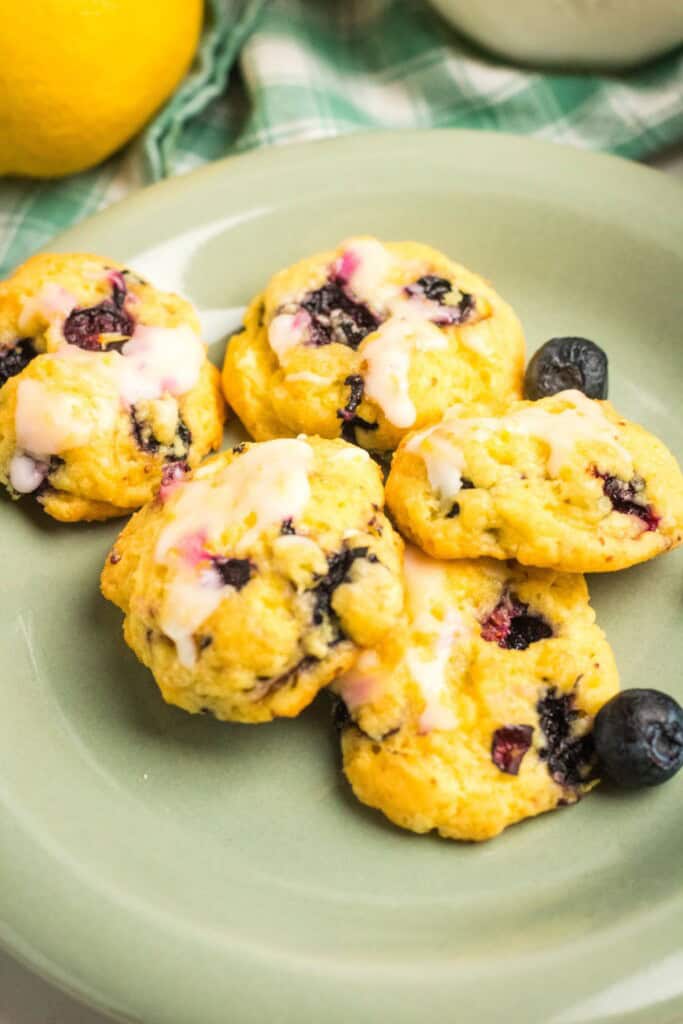 A green plate with lemon blueberry cake mix cookies.