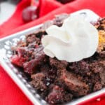 A square dish with the cake mix chocolate cherry cake.