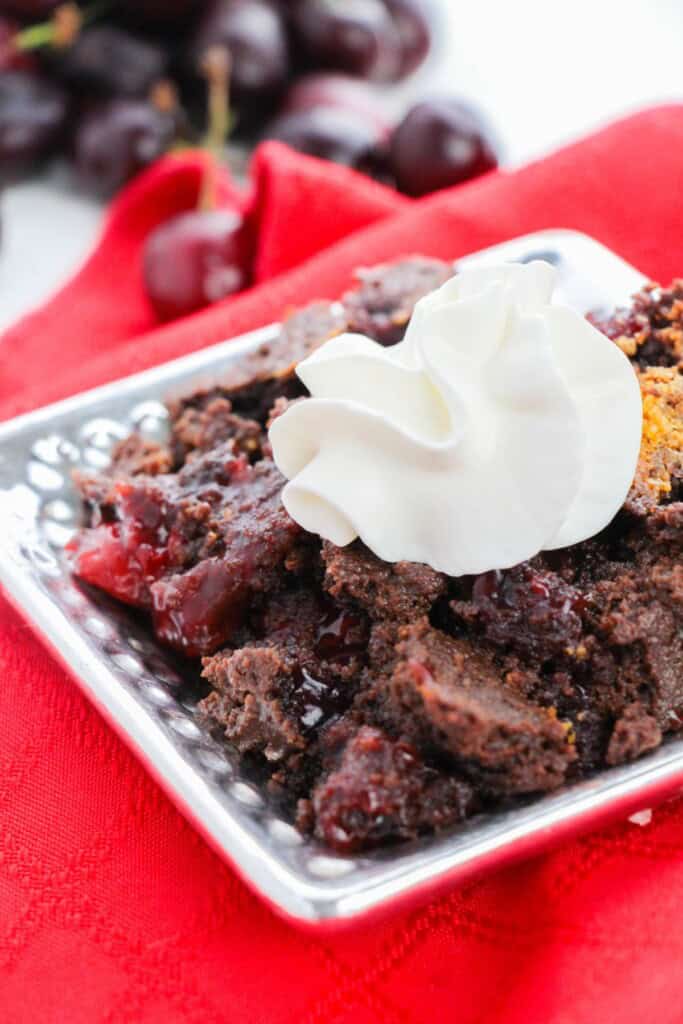 A square dish with the cake mix chocolate cherry cake.