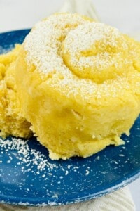 A yellow cake on a blue plate.
