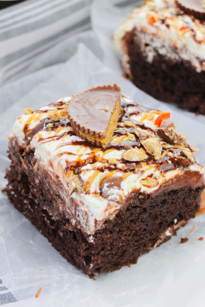 A peanut butter cup on top of the chocolate cake.