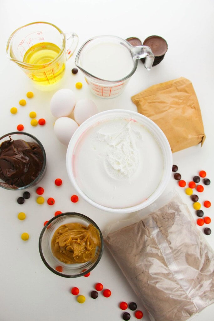 Cake mix, oil, peanut butter, cups and chocolate for the recipe.
