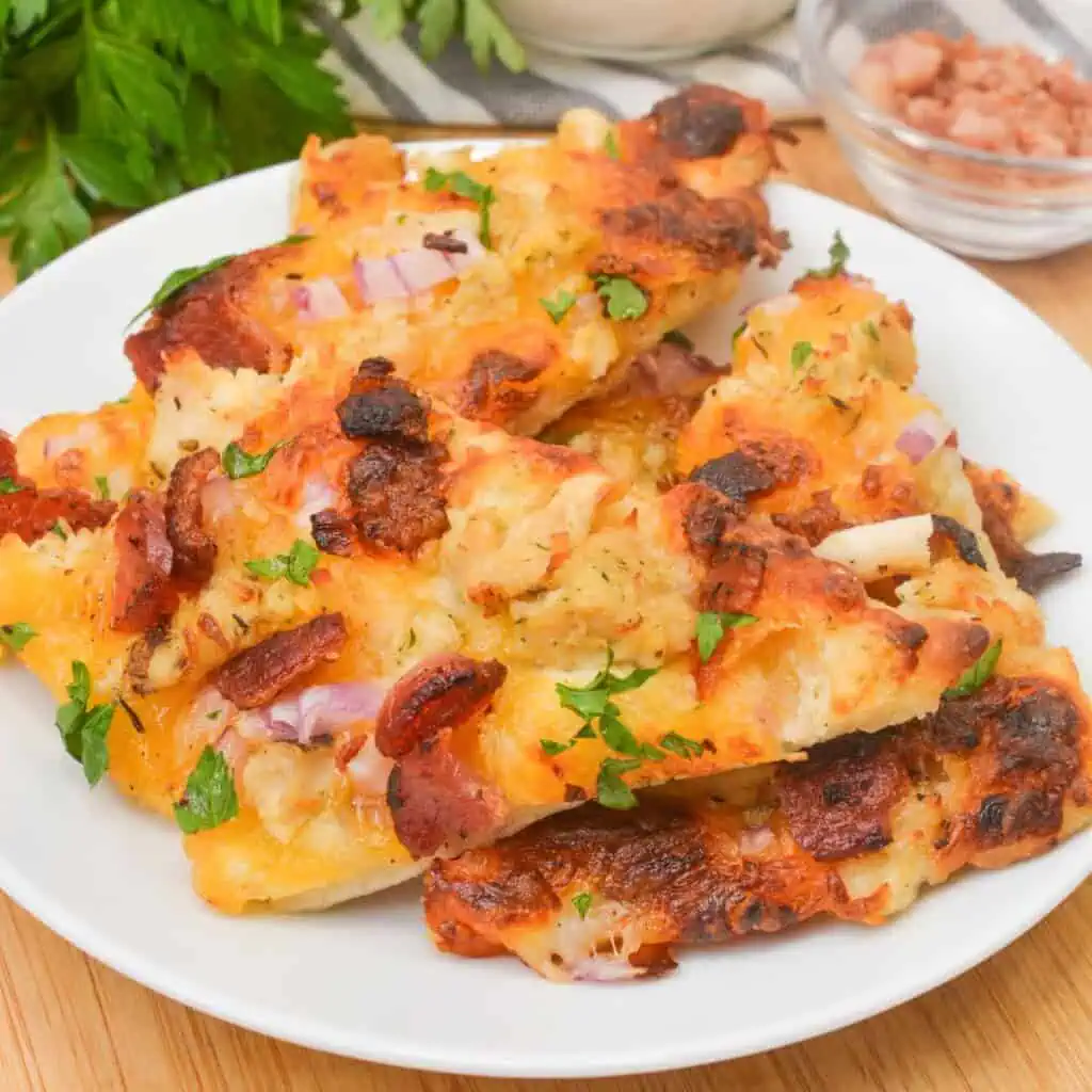 A white dish of bacon chicken ranch flatbread.