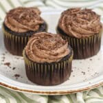 A plate with three cocoa pebbles cupcakes.