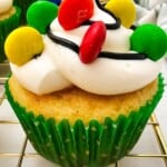 A christmas light cupcake with a green paper wrap.