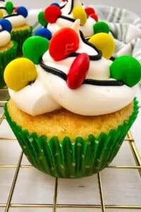 A christmas light cupcake with a green paper wrap.