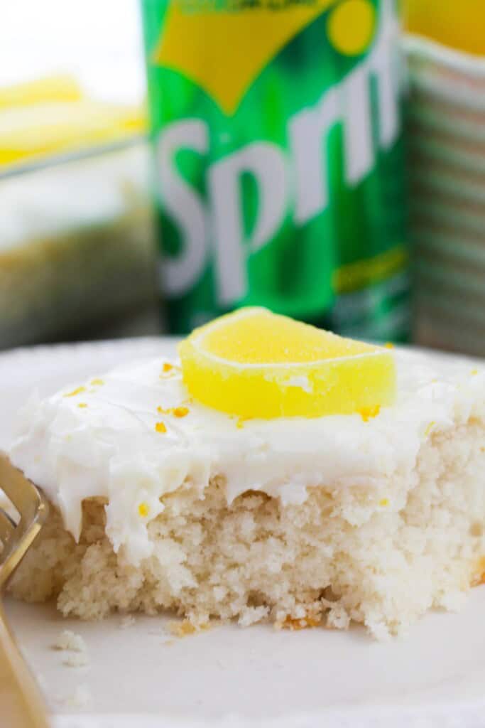 A slice of lemon sprite cake on a white plate.