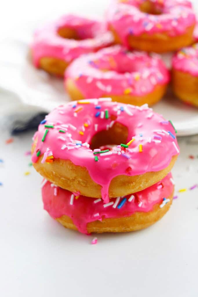 Stacks of pink sprinkle donuts.
