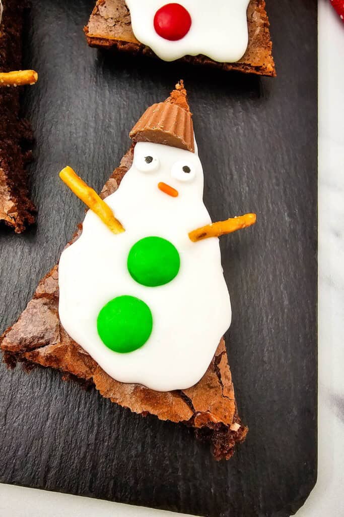 An adorable snowman brownie on a baking tray.