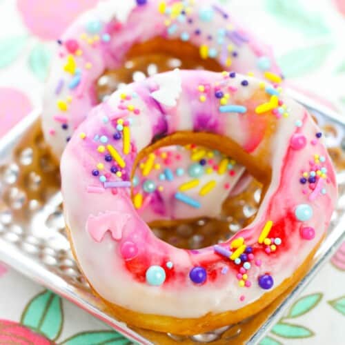 A plate of the unicorn donuts with colorful sprinkles.