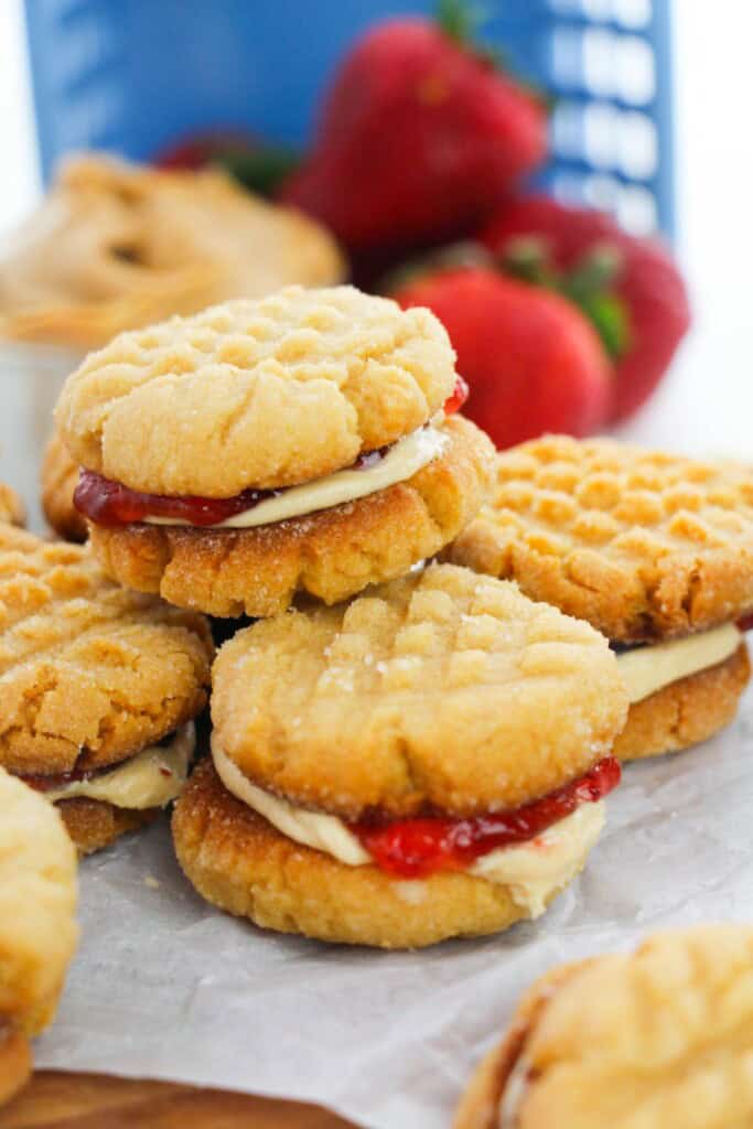 A stack of the desserts with strawberries in the background.