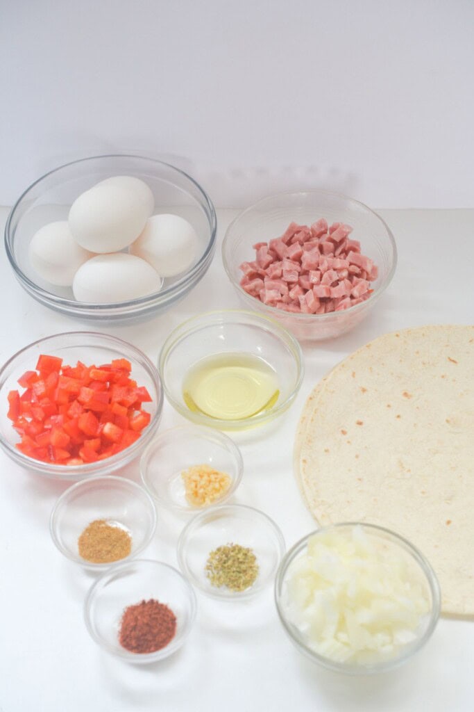 Egg, ham, tortillas and spices for the meal.